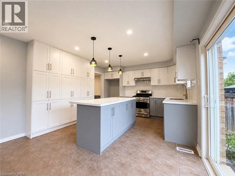 A spacious kitchen with white cabinets and a central island.