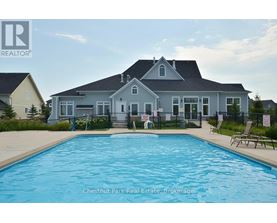 A large house with a pool in front of it.