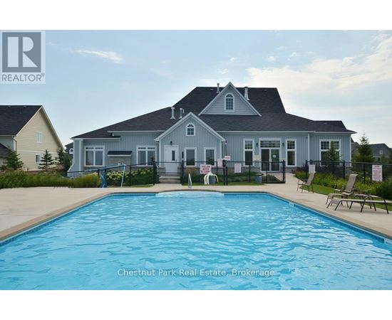 A large house with a pool in front of it.