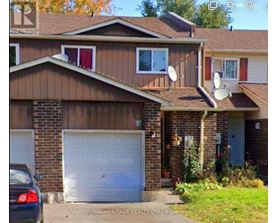 A house with a white garage door and a car parked in front.