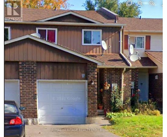 A house with a white garage door and a car parked in front.