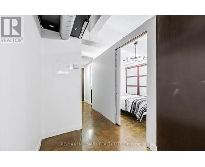A bedroom with a bed and a window is shown in the image.