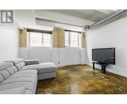 A living room with a grey sofa and a television.