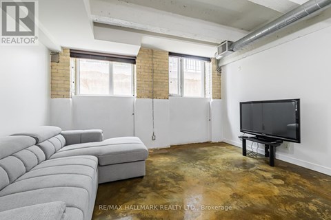 A living room with a grey sofa and a television.