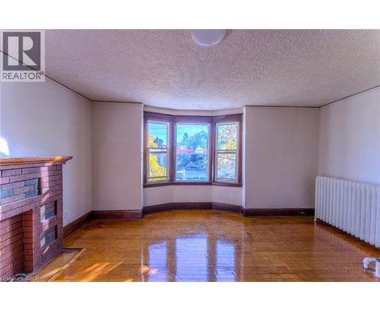 A room with a fireplace and a large window.