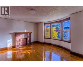 A room with a fireplace and wooden floors.