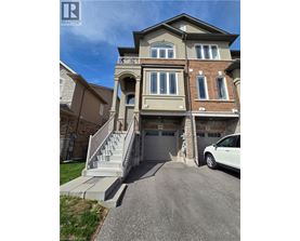 A two-story house with a garage and a car parked in front.