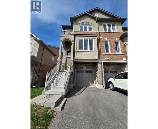 A two-story house with a garage and a car parked in front.