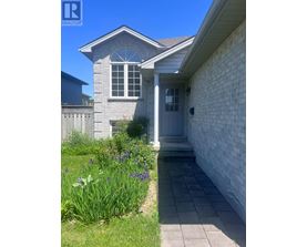 A house with a grey front door and a small porch.