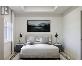 A bedroom with a large bed and a painting on the wall.