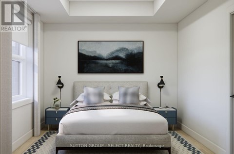 A bedroom with a large bed and a painting on the wall.