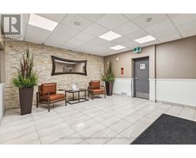 A waiting area with chairs and a flat screen TV.