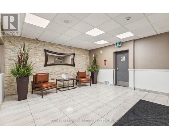 A waiting area with chairs and a flat screen TV.