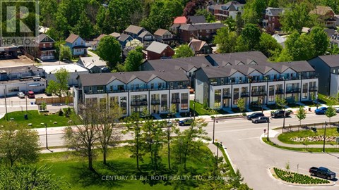 A real estate company's office building with a parking lot in front.