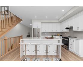 A modern kitchen with white cabinets and a central island.