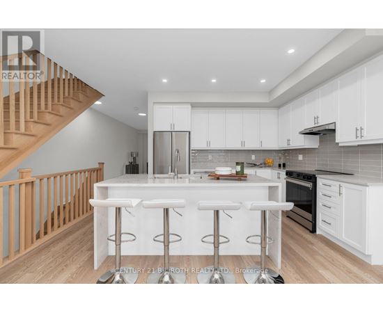 A modern kitchen with white cabinets and a central island.