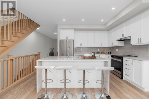 A modern kitchen with white cabinets and a central island.