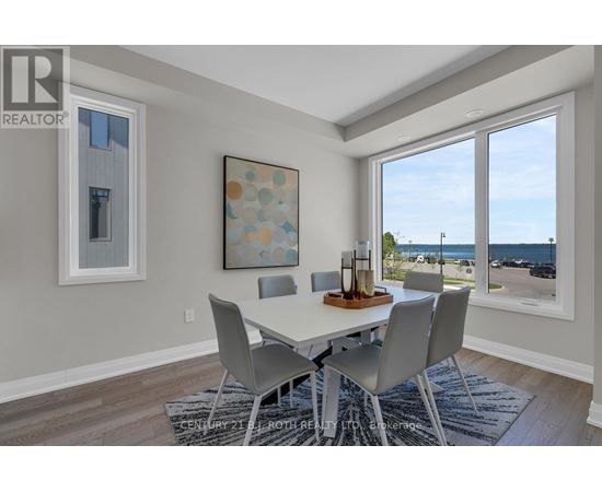 A dining room with a table and chairs and a view of the street outside.