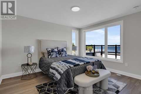 A bedroom with a large bed and a view of the ocean.
