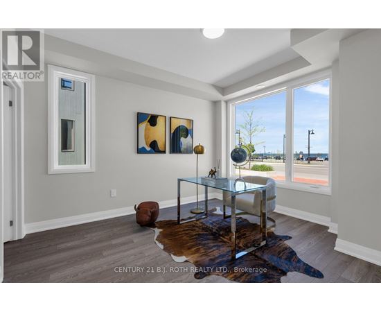 A modern living room with a glass coffee table and a cowhide rug.