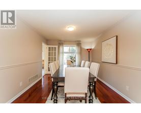 A dining room with a table set for four.