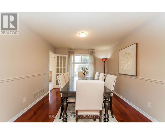 A dining room with a table set for four.