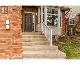 A house numbered 39 with a grey door and a white railing.