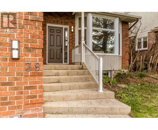 A house numbered 39 with a grey door and a white railing.