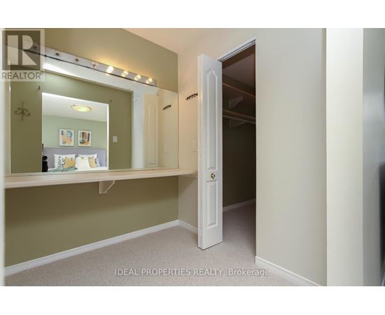 A bedroom with a mirror and a door.