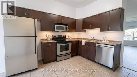 A kitchen with brown cabinets and stainless steel appliances.