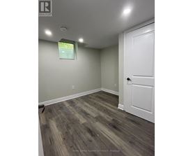 A room with a white door and a window with blinds.