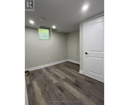 A room with a white door and a window with blinds.