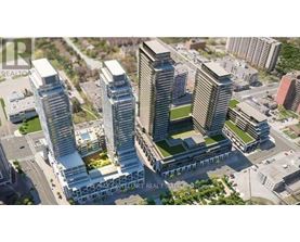 A tall building with a glass facade stands in front of other buildings.