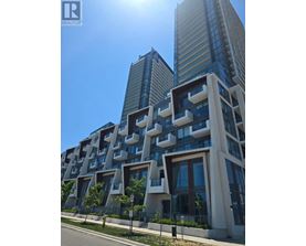 A modern building with a unique design stands tall against a clear sky.