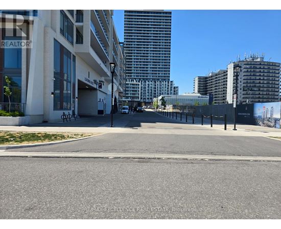 A street view with buildings and a sign that says REALTOR.