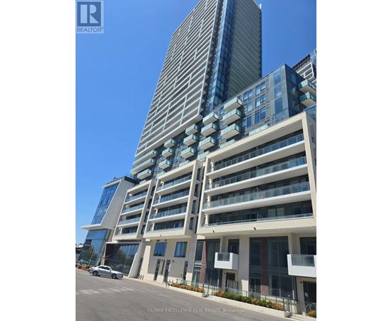 A tall building with a glass facade stands next to a shorter building with a white facade.