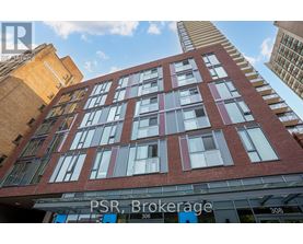 A tall red brick building with the words PSR Brokerage on the front.