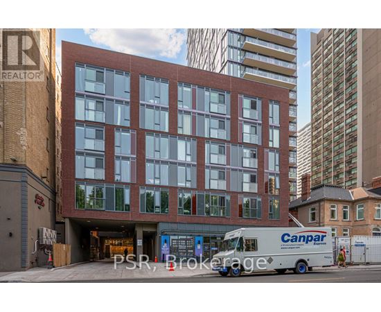 A Canpar delivery truck is parked in front of a multi-story building.