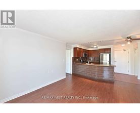 A spacious room with a reception desk and a ceiling fan.