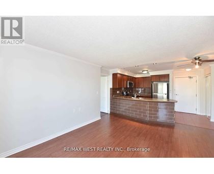 A spacious room with a reception desk and a ceiling fan.