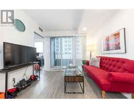 A living room with a red couch and a flat screen TV.