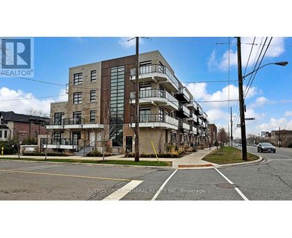 A multi-story building with a glass facade is situated on a street corner.