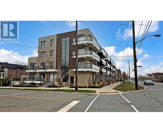 A multi-story building with a glass facade is situated on a street corner.