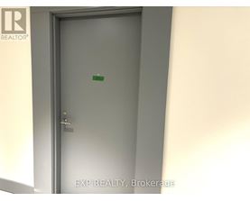 A door with a handle and a green sticker on it.