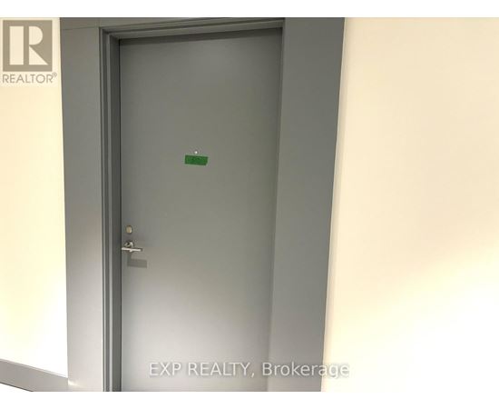 A door with a handle and a green sticker on it.