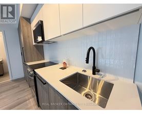 A modern kitchen with a sink and a microwave above it.
