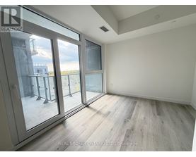 A room with a view of a balcony through a glass door.