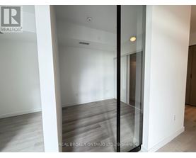 A room with a glass door and wooden flooring.