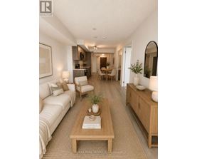 A well-lit, modern living room with a white sofa, wooden coffee table, and a dining area in the background.