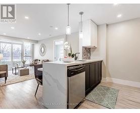 A modern kitchen with a large island and a dining area.